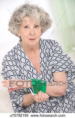 Woman with a cold compress on wrist View Large Photo Image Stock Photography - Woman with a cold compress on wrist. Fotosearch