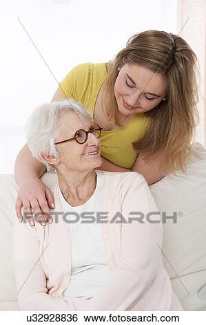 Stock Photograph - Woman with her hand on shoulder of woman. Fotosearch