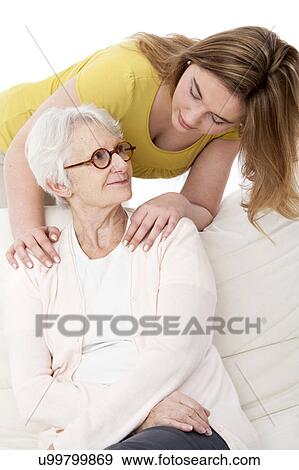 Stock Photo - Woman with her hands on shoulders of woma. Fotosearch