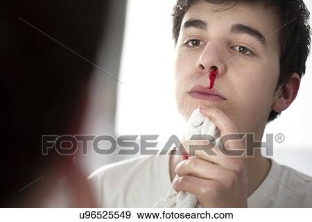 Stock Photo - Young man with nose bleed. Fotosearch
