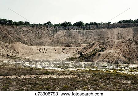Stock Image - Abandoned quarry chasm. Fotosearch