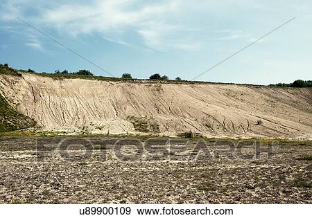 Stock Photo - Abandoned quarry with eroded hillside waste. Fotosearch
