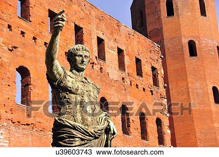 Stock Image - "Ancient Roman bronze statue of Emperor Caesar, Porte Palatine city gate, Turin, Piedmont, Italy". Fotosearch