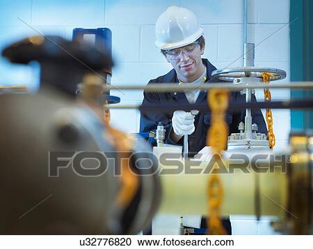 Apprentice engineer working in power station View Large Photo Image Stock Image - Apprentice engineer working in power station. Fotosearch