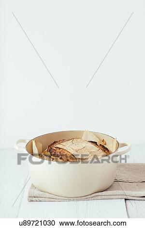 Stock Image - Artisan sourdough bread in saucepan. Fotosearch