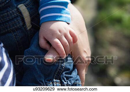 Stock Photo - "Baby boy holding mother's thumb, focus on hands". Fotosearch