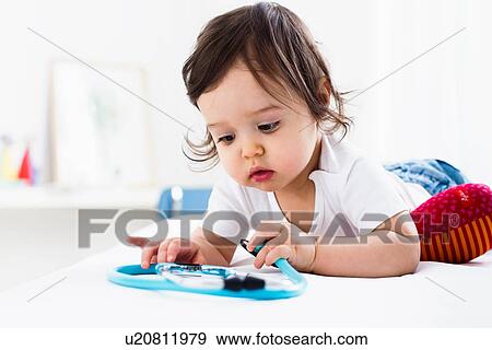 Stock Photo - Baby boy playing on floor. Fotosearch