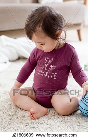 Baby boy playing on floor View Large Photo Image Stock Photo - Baby boy playing on floor. Fotosearch