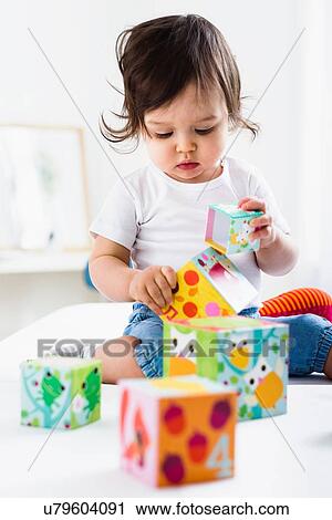 Baby boy playing on floor with toy bricks View Large Photo Image Stock Image - Baby boy playing on floor with toy bricks. Fotosearch