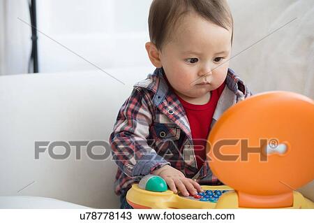 Baby boy using top computer View Large Photo Image Stock Image - Baby boy using top computer. Fotosearch