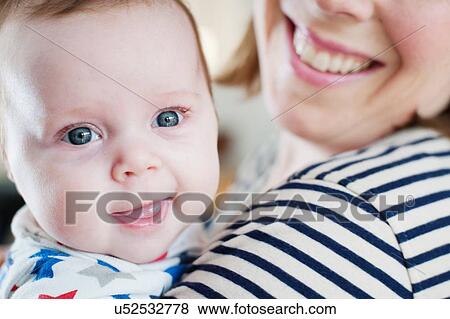 Baby girl smiling at camera View Large Photo Image Stock Photo - Baby girl smiling at camera. Fotosearch