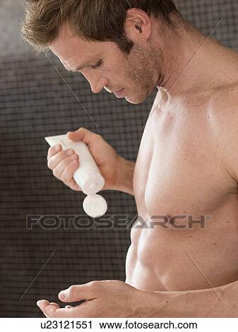 Bare chested muscular man in bathroom applying moisturizer View Large Photo Image Stock Image - Bare chested muscular man in bathroom applying moisturizer. Fotosearch