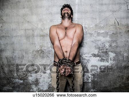Bare chested young man with chains wrapped around his wrists View Large Photo Image Stock Photograph - Bare chested young man with chains wrapped around his wrists. Fotosearch