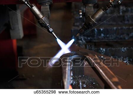 Blow torches with flames crossing View Large Photo Image Stock Photo - Blow torches with flames crossing. Fotosearch