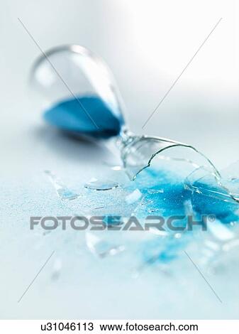 Blue sand pouring out of broken glass hourglass View Large Photo Image Stock Image - Blue sand pouring out of broken glass hourglass. Fotosearch