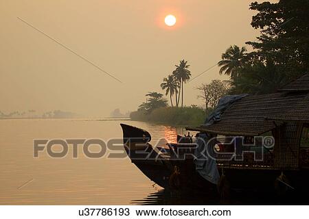 "Boat on water at sunrise, Kerala, India" View Large Photo Image Stock Image - "Boat on water at sunrise, Kerala, India". Fotosearch