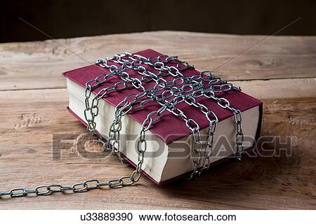Book with chains wrapped around it View Large Photo Image Stock Image - Book with chains wrapped around it. Fotosearch