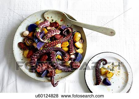 Bowl of octopus tentacles and potatoes View Large Photo Image Stock Photo - Bowl of octopus tentacles and potatoes. Fotosearch
