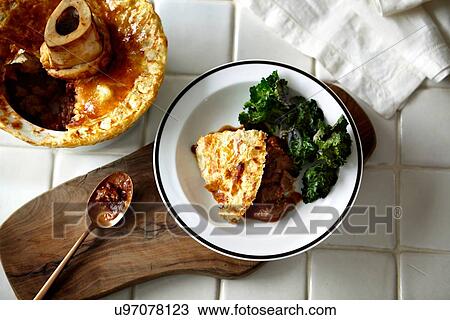Bowl of pot pie and cabbage on chopping board View Large Photo Image Stock Image - Bowl of pot pie and cabbage on chopping board. Fotosearch