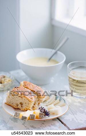 Stock Image - Bowl of soup with focaccia and cheese in kitchen. Fotosearch
