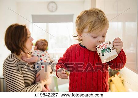 Boy drinking from mug View Large Photo Image Stock Photo - Boy drinking from mug. Fotosearch
