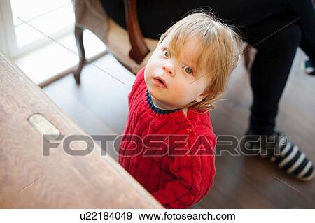 Stock Photo - Boy looking up towards camera. Fotosearch