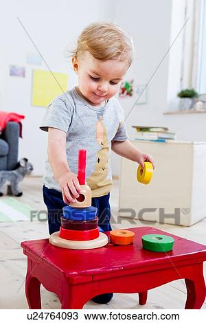Boy playing with blocks at home View Large Photo Image Stock Image - Boy playing with blocks at home. Fotosearch
