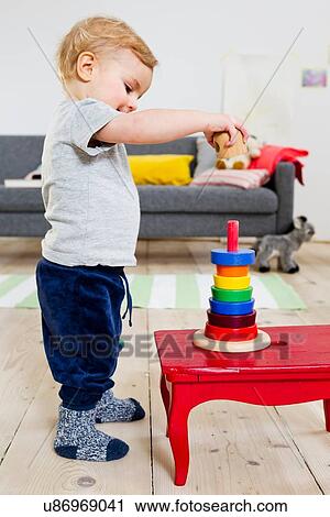 Stock Image - Boy playing with blocks at home. Fotosearch