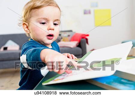 Boy pointing at book View Large Photo Image Stock Photo - Boy pointing at book. Fotosearch