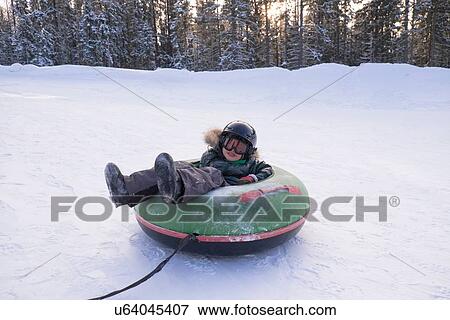"Boy snow sledging on rubber ring, Nizhniy Tagil, Sverdlovsk Region, Russia" View Large Photo Image Stock Photo - "Boy snow sledging on rubber ring, Nizhniy Tagil, Sverdlovsk Region, Russia". Fotosearch