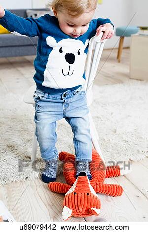 Boy stepping on toy View Large Photo Image Stock Image - Boy stepping on toy. Fotosearch