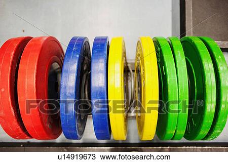 Brightly coloured barbell weights in a row View Large Photo Image Stock Image - Brightly coloured barbell weights in a row. Fotosearch