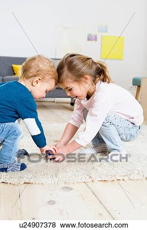 Brother and sister playing at home View Large Photo Image Stock Photo - Brother and sister playing at home. Fotosearch