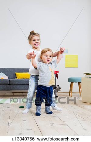 Brother and sister playing at home View Large Photo Image Stock Photograph - Brother and sister playing at home. Fotosearch