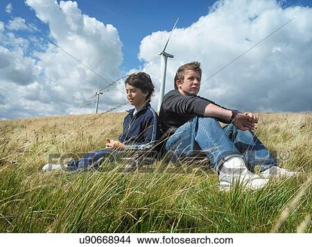 Brothers sitting together at windfarm View Large Photo Image Picture - Brothers sitting together at windfarm. Fotosearch