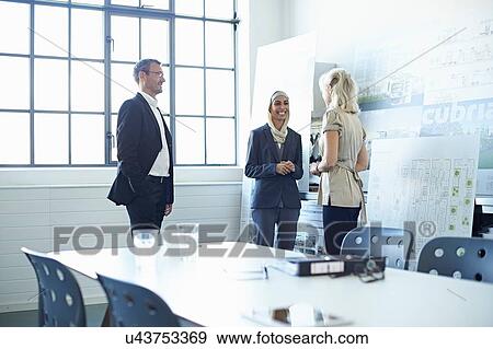 Business team discussing presentation ideas in office View Large Photo Image Stock Photo - Business team discussing presentation ideas in office. Fotosearch