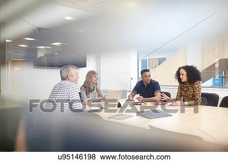 Business team meeting at conference table View Large Photo Image Stock Photo - Business team meeting at conference table. Fotosearch