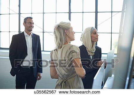 Business team presenting ideas in office View Large Photo Image Stock Photo - Business team presenting ideas in office. Fotosearch