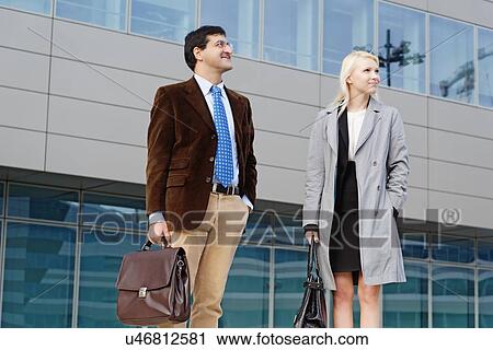 "Businessman and businesswoman, standing together, outdoors" View Large Photo Image Stock Image - "Businessman and businesswoman, standing together, outdoors". Fotosearch