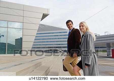 "Businessman and businesswoman, walking up steps together" View Large Photo Image Stock Image - "Businessman and businesswoman, walking up steps together". Fotosearch