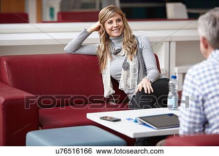 Businessman and woman meeting on office sofas View Large Photo Image Stock Photograph - Businessman and woman meeting on office sofas. Fotosearch