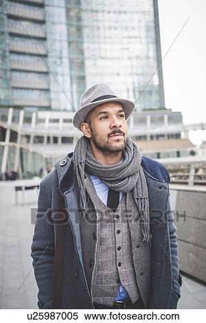 Stock Photography - Businessman walking outside city office buildings. Fotosearch