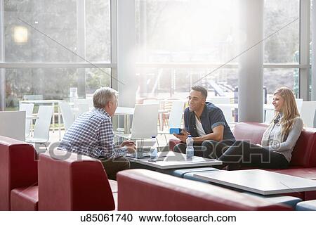 Businessmen and woman meeting on office sofas View Large Photo Image Stock Image - Businessmen and woman meeting on office sofas. Fotosearch