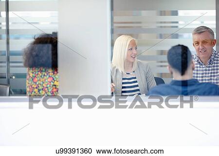 Businessmen and women having meeting at conference table View Large Photo Image Stock Image - Businessmen and women having meeting at conference table. Fotosearch