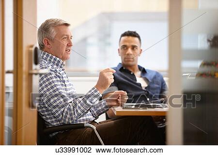 Businessmen having team meeting in conference room View Large Photo Image Stock Image - Businessmen having team meeting in conference room. Fotosearch