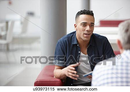 Stock Photography - Businessmen meeting on office sofas. Fotosearch