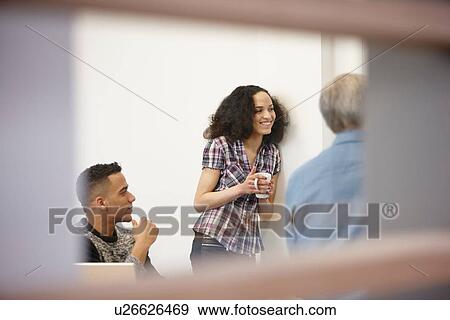 Businesswoman and men drinking coffee in office meeting View Large Photo Image Stock Photo - Businesswoman and men drinking coffee in office meeting. Fotosearch
