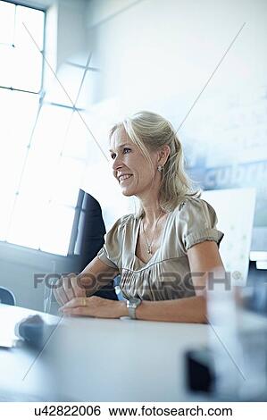 Businesswoman at conference table in office meeting View Large Photo Image Stock Photograph - Businesswoman at conference table in office meeting. Fotosearch