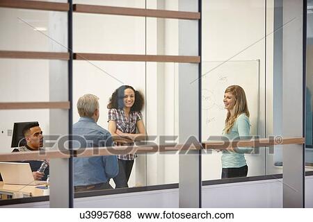 Stock Photo - Businesswoman making team presentation on office whiteboard. Fotosearch