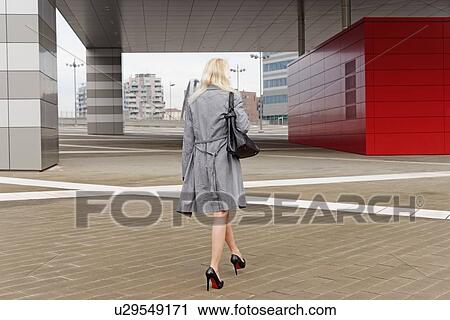 "Businesswoman, walking outdoors, rear view" View Large Photo Image Stock Image - "Businesswoman, walking outdoors, rear view". Fotosearch